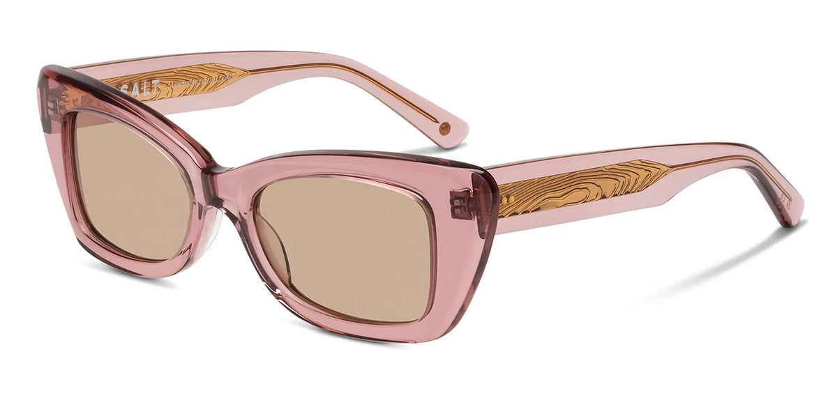 The SALT. Tory sunglasses by SALT. feature pink translucent Japanese acetate frames with square lenses and tan wooden-textured detailing on the arms, displayed at a three-quarter angle against a white background. Expertly made in Japan, these stylish frames are fitted with polarized optical lenses.