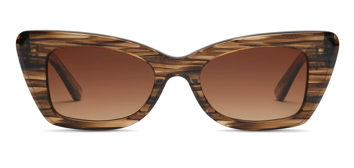 The SALT. Tory sunglasses by SALT. are brown cat-eye frames with a striped woodgrain pattern, crafted from premium Japanese acetate and featuring gradient brown lenses, shown from the front on a white background.