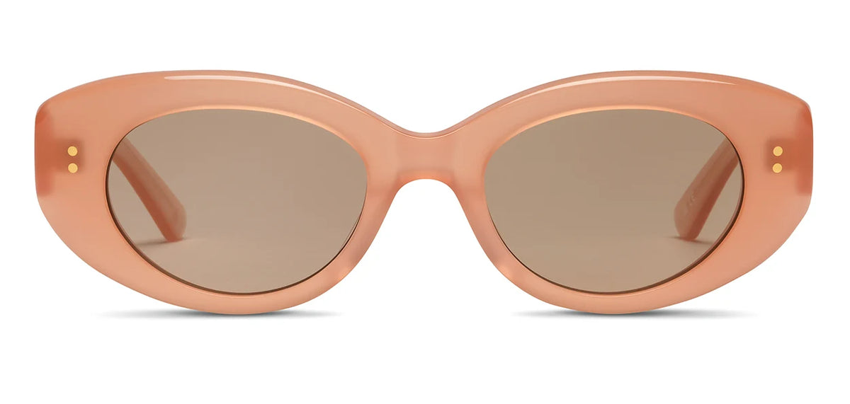 Front view of the SALT. Cass sunglasses, featuring thick, peach-colored frames crafted from premium Japanese acetate and brown tinted oval lenses. Two small gold dots accent each temple near the hinges.