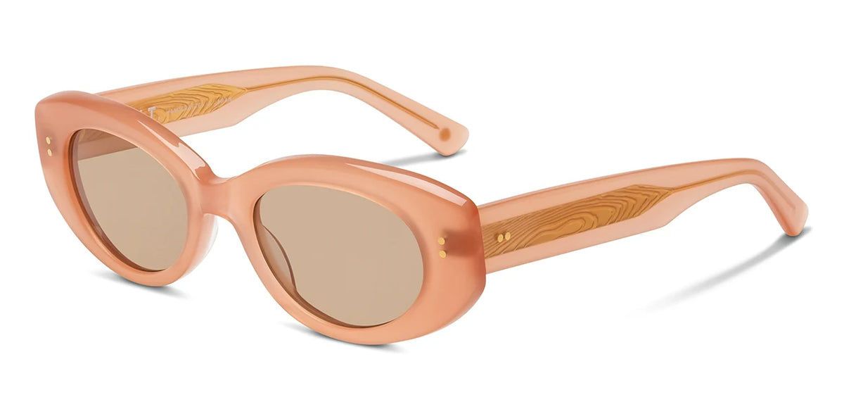 The SALT. Cass sunglasses by SALT. feature peach-colored oval frames made from premium Japanese acetate, with thick, translucent construction and light brown tinted lenses, showcased against a white background.