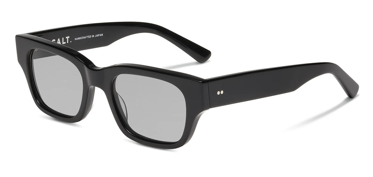 The SALT. Burnet sunglasses by SALT. feature a black rectangular silhouette with thick frames made from premium Japanese acetate and gray anti-reflective lenses, positioned at an angle to showcase both the front and side profiles.