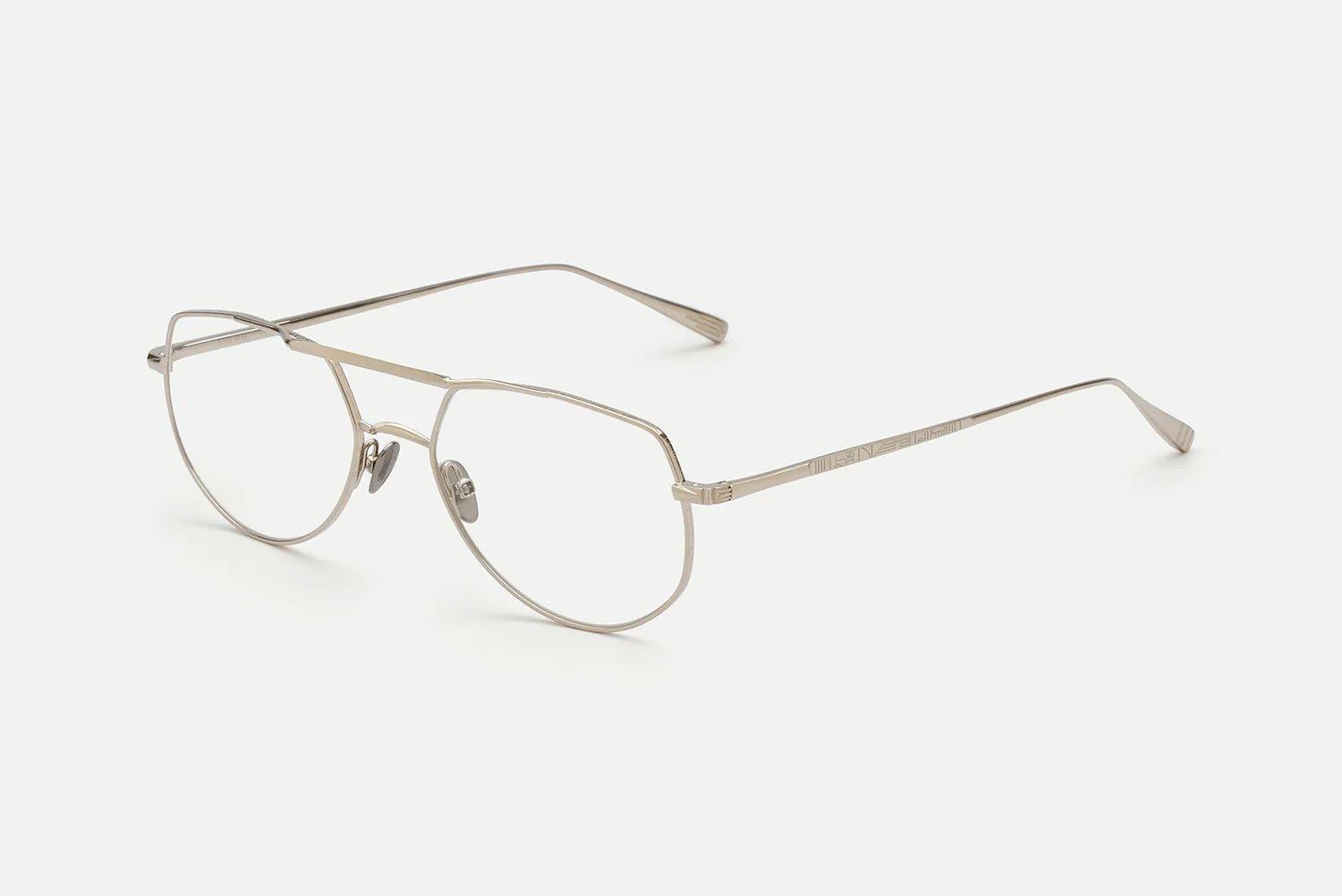 The AHLEM Cadet by AHLEM are silver metal aviator-style eyeglasses, handcrafted in France with clear lenses, thin frames, adjustable nose pads, and straight temple arms, displayed on a white background.