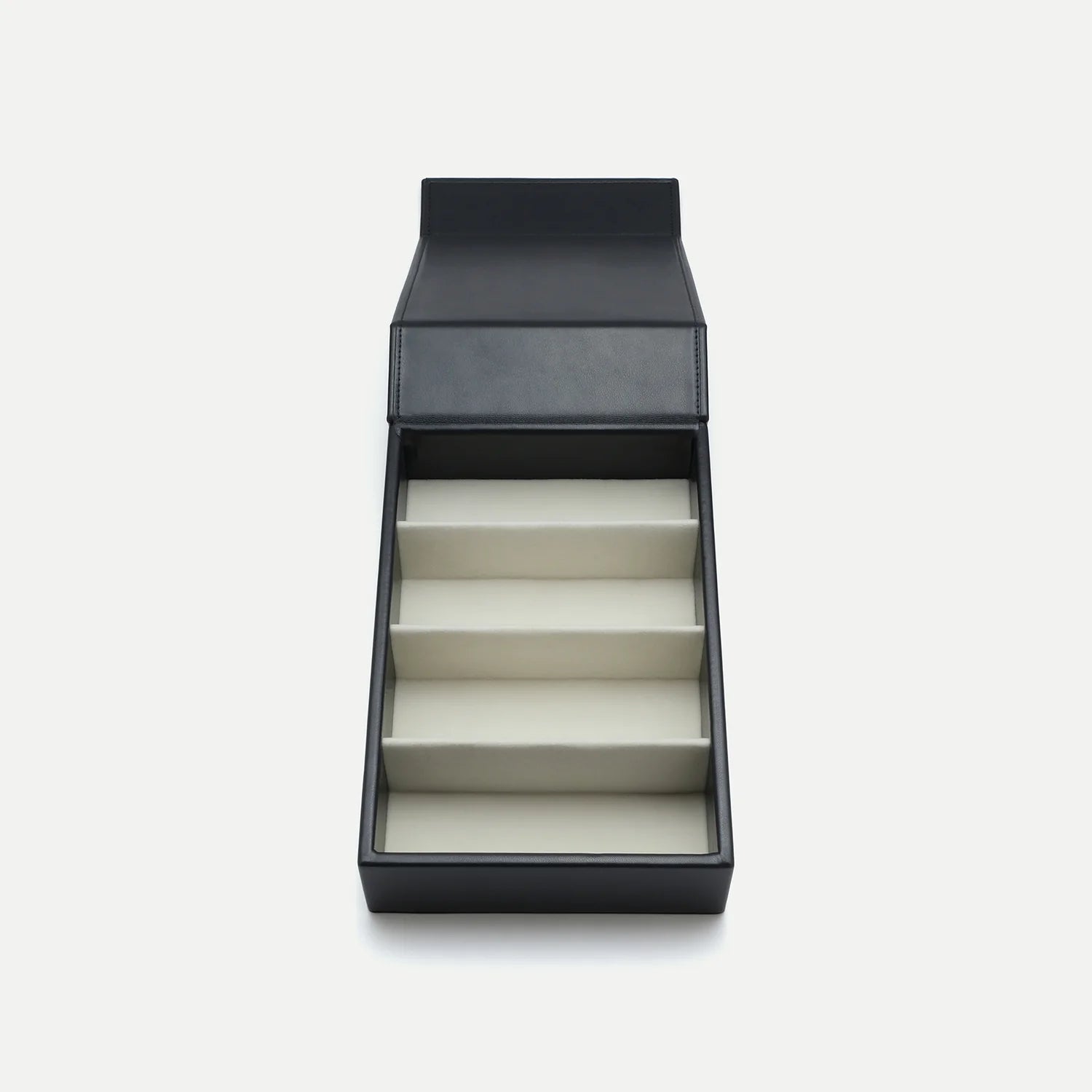 Introducing the AHLEM Voyager Collection: 4-Unit Travel Case by AHLEM—a sophisticated black rectangular case with an open lid, featuring four angled, padded slots inside. Expertly crafted for storing or displaying items such as eyewear or watches, this refined travel case evokes the elegance of Nappa leather and provides both style and protection for your collection. The product is showcased against a plain white background.