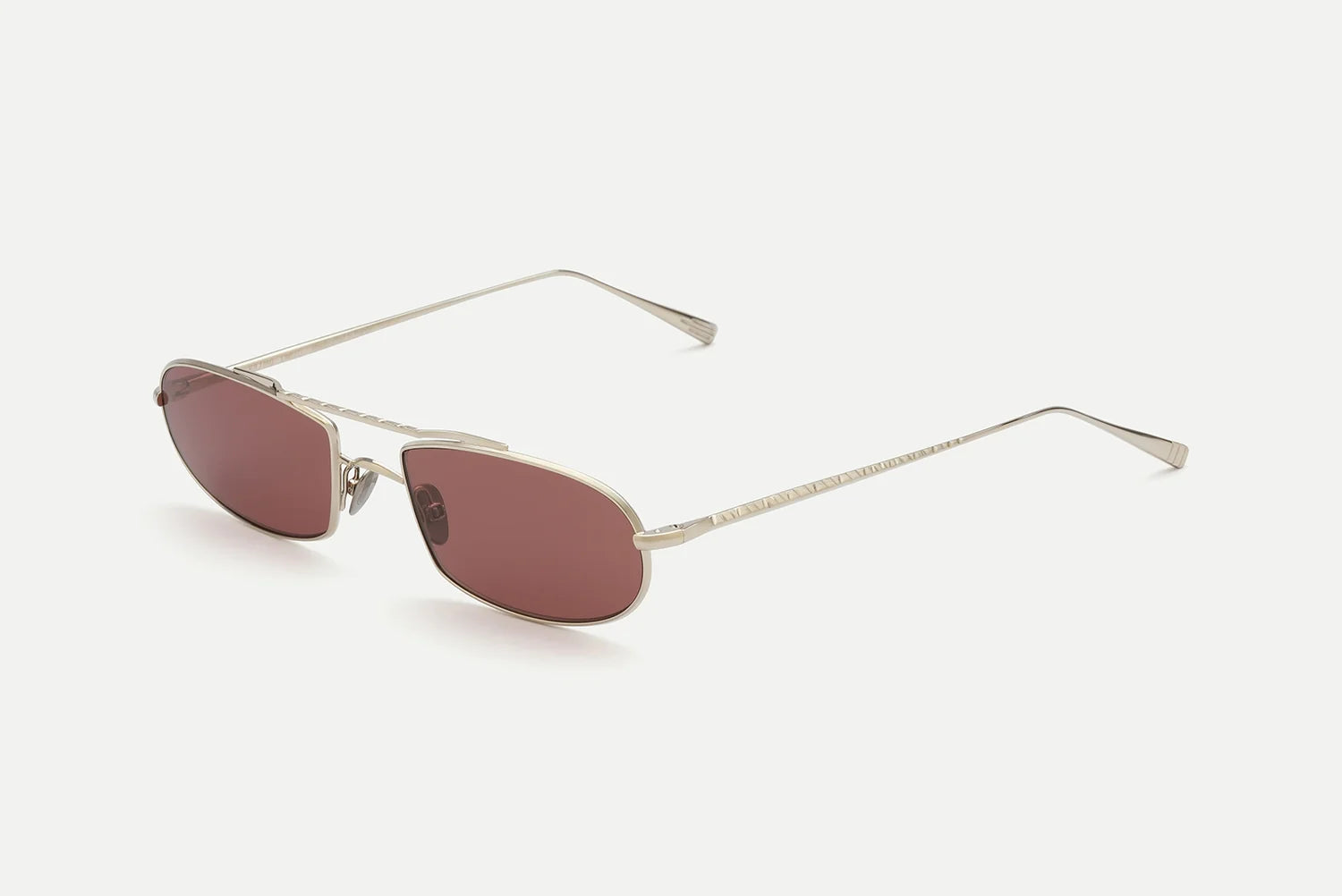 AHLEM Guerin by AHLEM: Unisex silver metal sunglasses featuring slim arms and rectangular, dark rose-tinted lenses, handcrafted in France for 100% UV protection, shown against a plain white background.