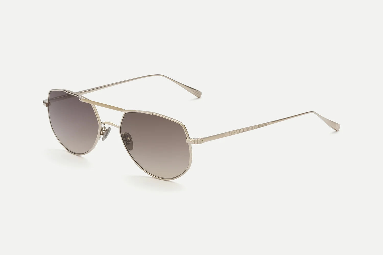 Sunglasses with gold frame and brown gradient lenses on a white background