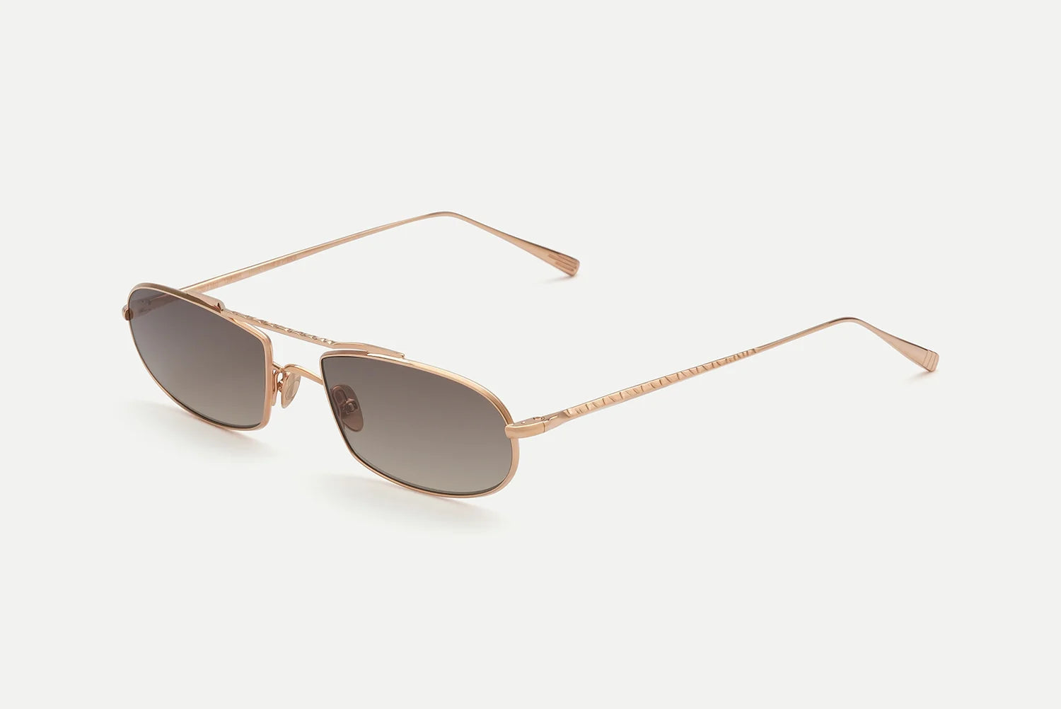 AHLEM Guerin unisex sunglasses by AHLEM, featuring gold metal frames and rectangular dark tinted lenses with 100% UV protection, displayed at an angle on a light background.