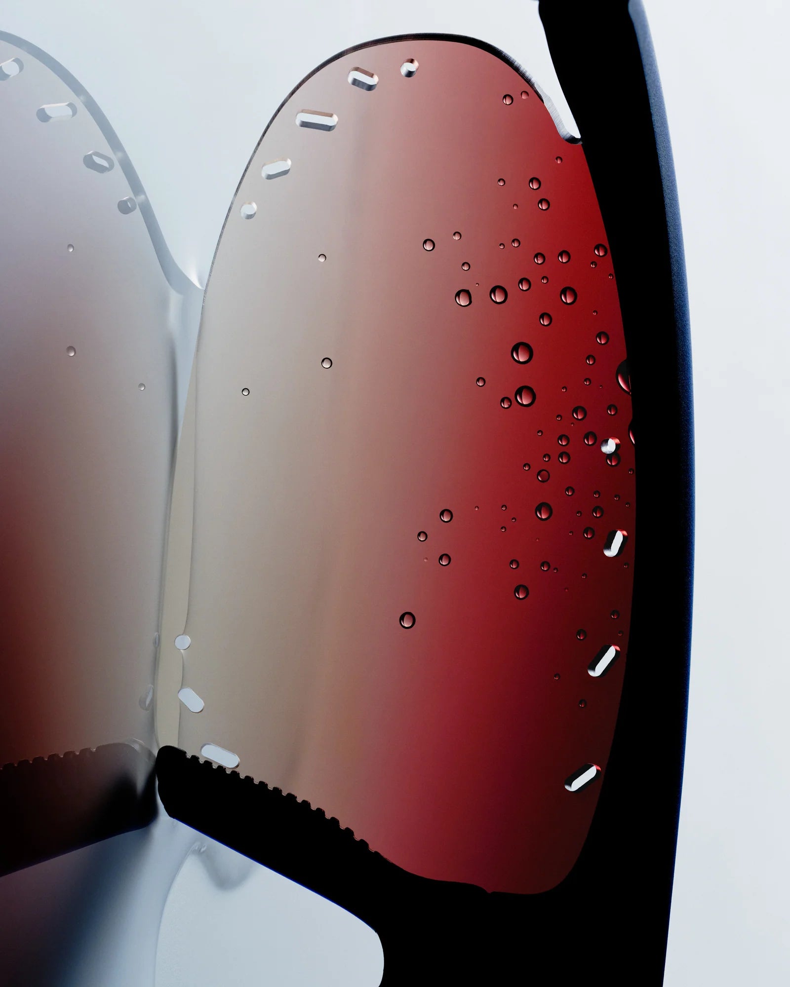 Close-up of a car mirror with a red reflective surface