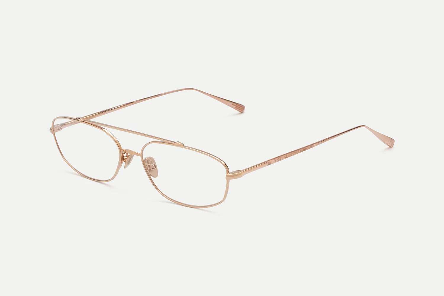 A pair of slim metal eyeglasses with a rose gold finish, featuring a double-bridge design and clear lenses, set against a plain off-white background.