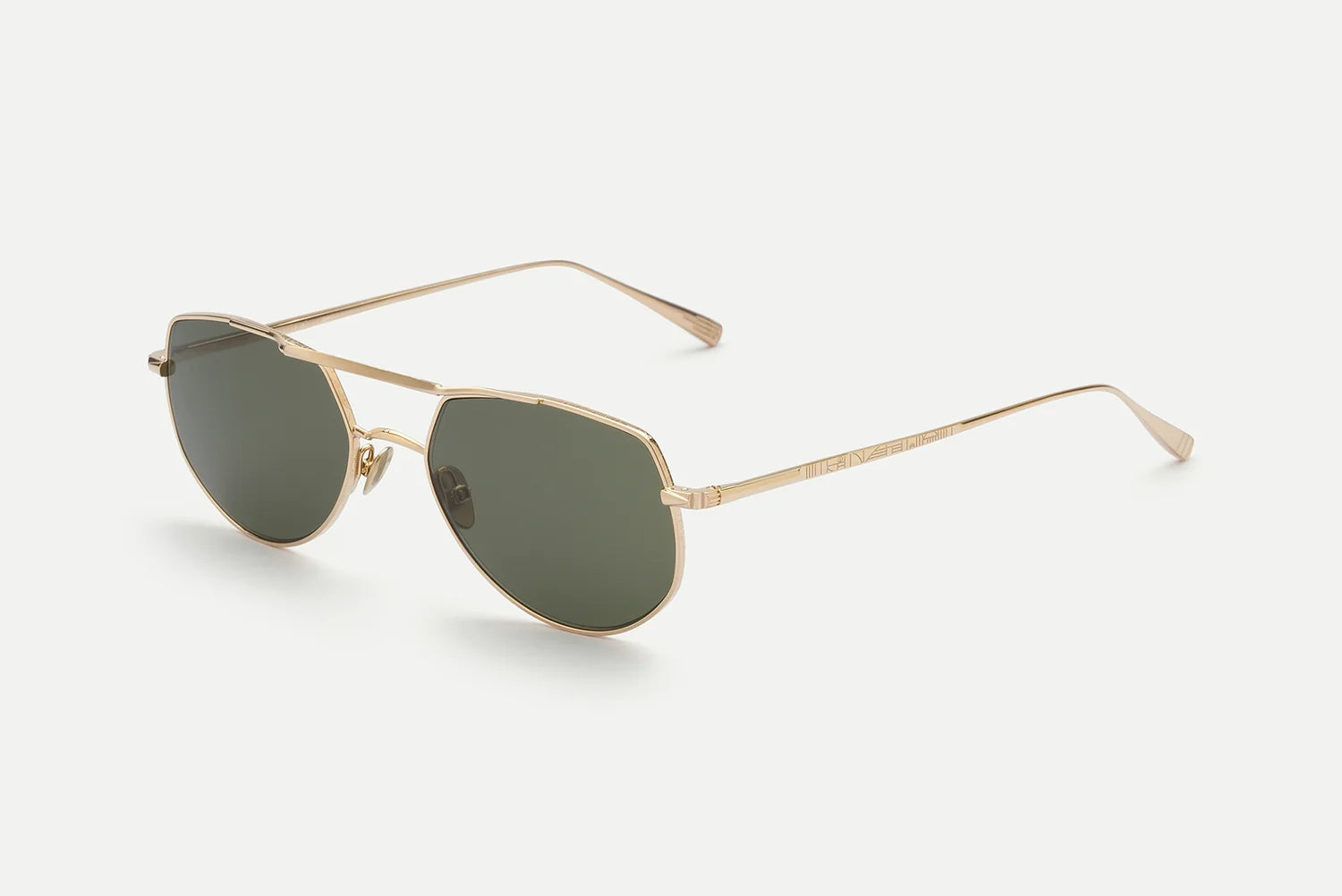 AHLEM Cadet sunglasses by AHLEM, handcrafted in France, feature thin gold metal aviator frames with dark green, slightly geometric lenses. Displayed on a plain white background, the modern minimalist design is elegantly finished with 22k gold detailing.