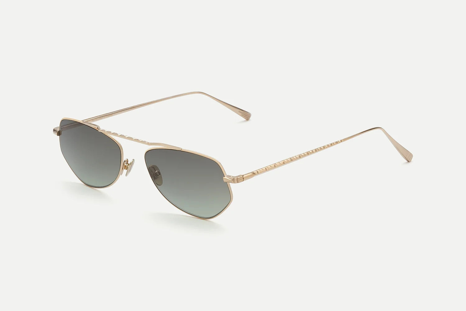Introducing the AHLEM Julien by AHLEM: sophisticated gold metal sunglasses handcrafted in France, featuring thin frames and a striking hexagonal silhouette with gradient gray lenses. Inspired by classic aviator styles, these elegant shades boast slim temples with subtle textured detailing and adjustable nose pads for all-day comfort. Photographed against a plain white background.