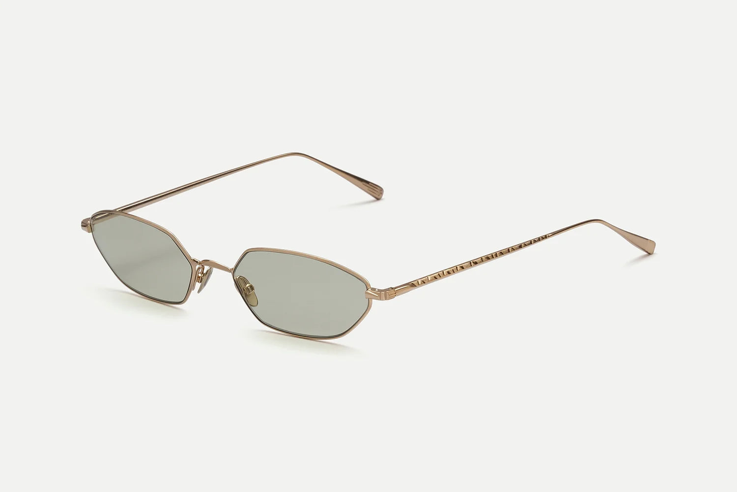 The AHLEM Iris sunglasses by AHLEM feature slightly rounded rectangular lenses and thin arms in a gold-framed geometric design, handcrafted in France from luxurious 22k gold, shown on a white background.
