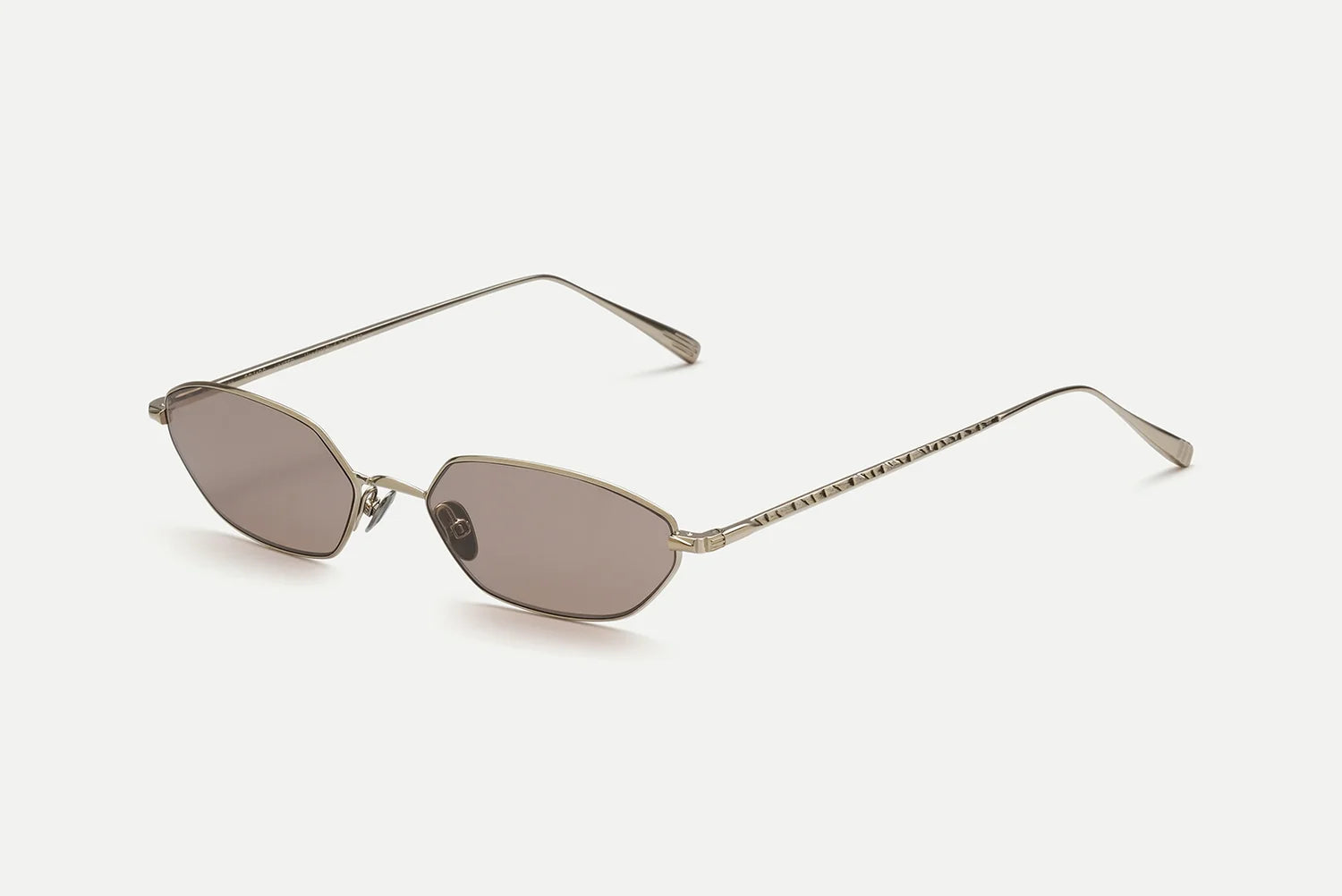 The AHLEM Iris by AHLEM features gold-framed geometric sunglasses with thin arms and rectangular, brown-tinted lenses, handcrafted in France and displayed on a plain white background.