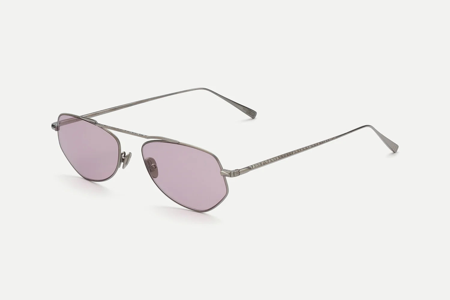 The AHLEM Julien by AHLEM are silver metal-framed aviator sunglasses featuring light purple-tinted lenses, thin arms, and nose pads, handcrafted in France and displayed on a white background.