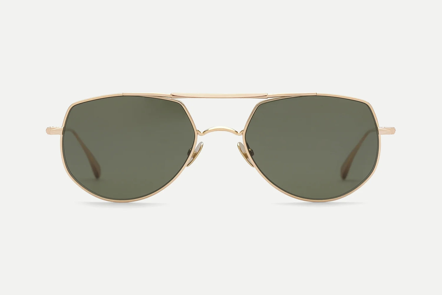 A pair of aviator-style sunglasses with a thin gold-tone metal frame and dark green lenses, shown against a light gray background.