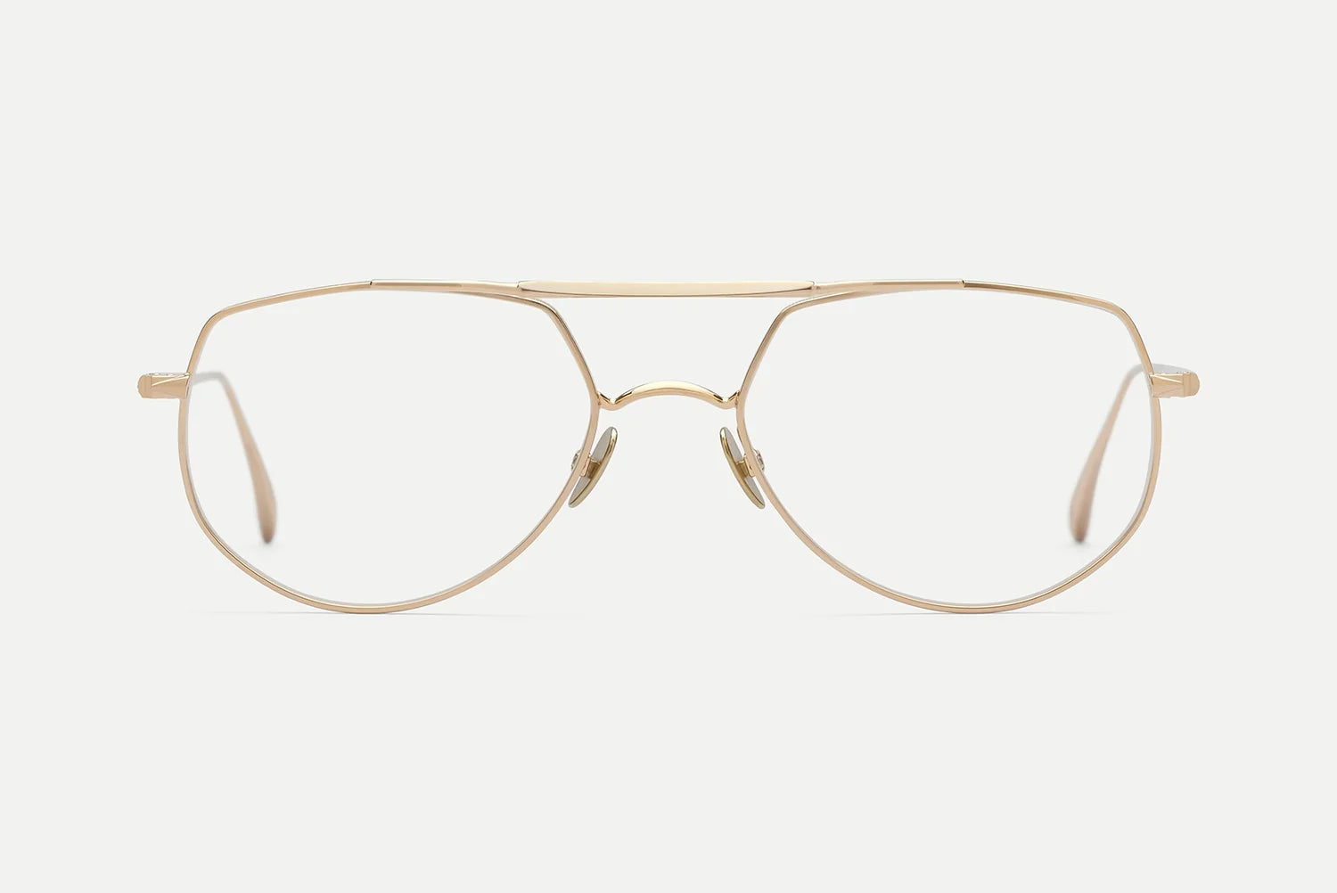 The AHLEM Cadet by AHLEM are handcrafted aviator-style eyeglasses made in France. Shown against a plain white background, these thin gold frames feature clear lenses, a double bridge design, and elegant 22k gold detailing.