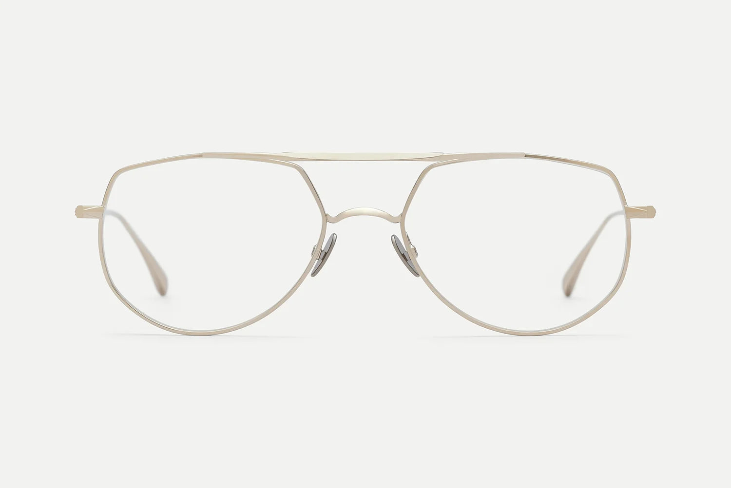 The AHLEM Cadet by AHLEM features thin, silver metal aviator eyeglass frames with a double bridge, clear lenses, and adjustable nose pads. Handcrafted in France, these glasses are displayed on a plain white background.