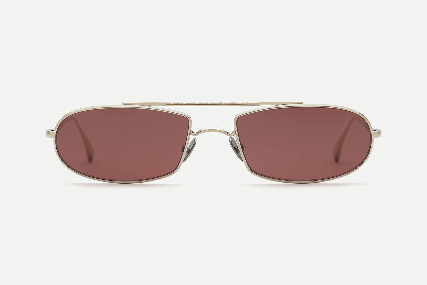 The AHLEM Guerin by AHLEM is a pair of unisex aviator-style sunglasses featuring thin metallic frames and dark reddish-brown tinted lenses that provide 100% UV protection, displayed against a plain white background.