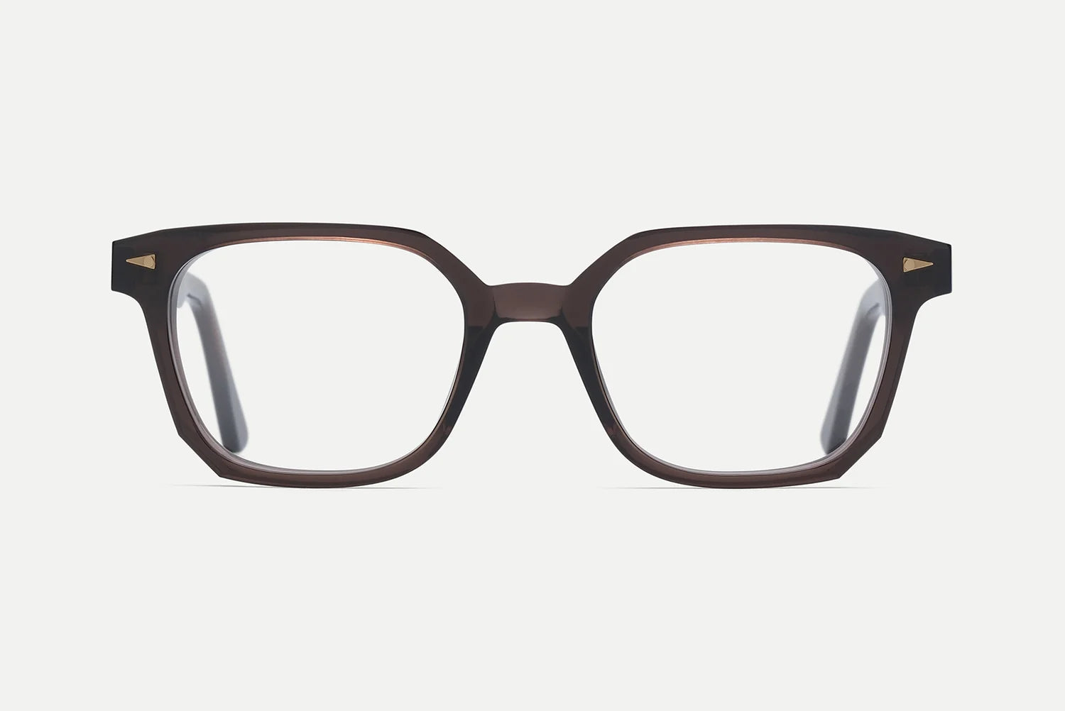 Presenting the AHLEM Houdon by AHLEM: a pair of brown rectangular eyeglasses with thick handcrafted acetate frames, featuring gold triangle accents on the upper corners and finished with premium steel hardware, displayed on a white background.
