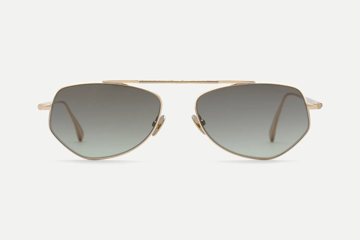 AHLEM Julien sunglasses by AHLEM, featuring gold-colored frames with geometric hexagonal lenses and a dark gradient tint, are displayed against a plain white background. Handcrafted in France with 22k gold accents, these sunglasses include matching gold-tone nose pads and arms for a luxurious finish.