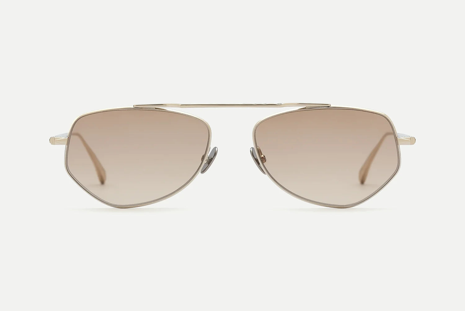 Introducing the AHLEM Julien by AHLEM: geometric sunglasses featuring 22k gold metal frames and light brown gradient lenses, handcrafted in France, shown from the front on a plain white background.