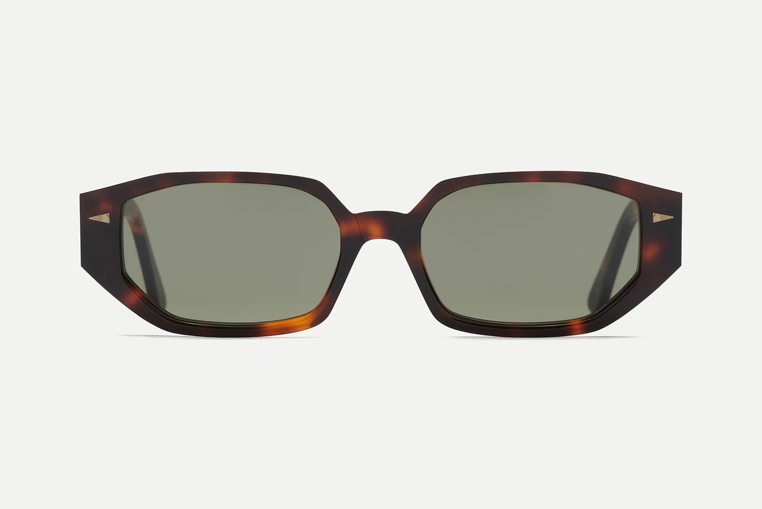 Front view of the AHLEM Poitou sunglasses by AHLEM, featuring oversized geometric tortoiseshell frames and dark green lenses, handcrafted from premium Italian acetate with 22k gold hardware accents, displayed on a white background.