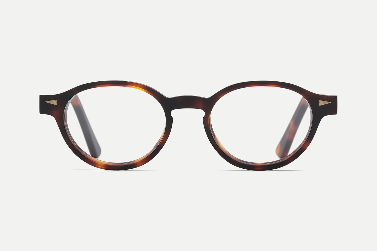 AHLEM St Marcel round tortoiseshell eyeglasses with clear lenses, handcrafted in France by AHLEM from premium Italian acetate and accented with 22k gold hardware, viewed from the front on a white background.