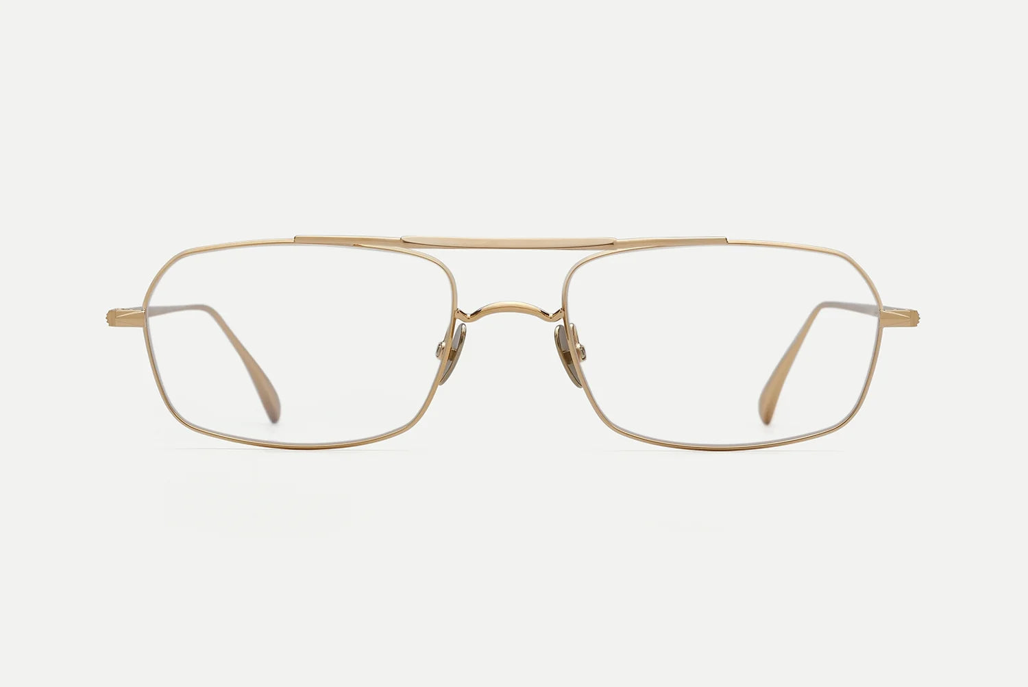A pair of square aviator-style eyeglasses with a thin gold metal frame and clear lenses, shown against a plain light gray background.