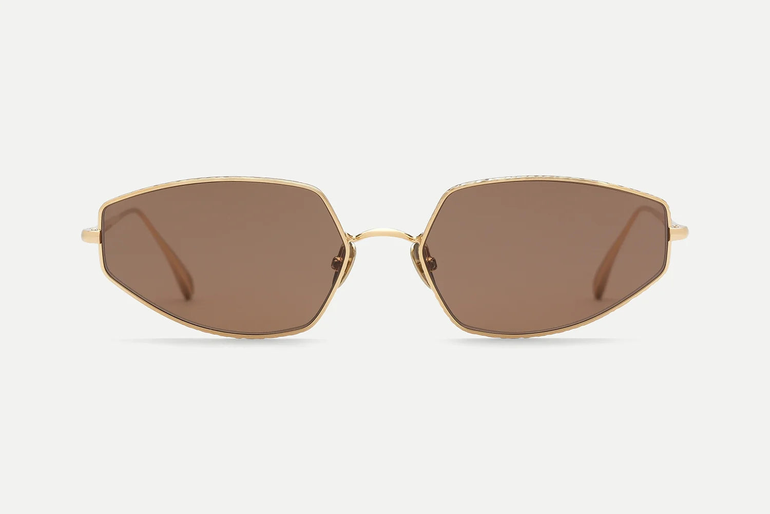 AHLEM Yvonne sunglasses by AHLEM, handcrafted in France with gold frames and large, geometric brown lenses inspired by Bauhaus design, shown from the front against a plain white background.