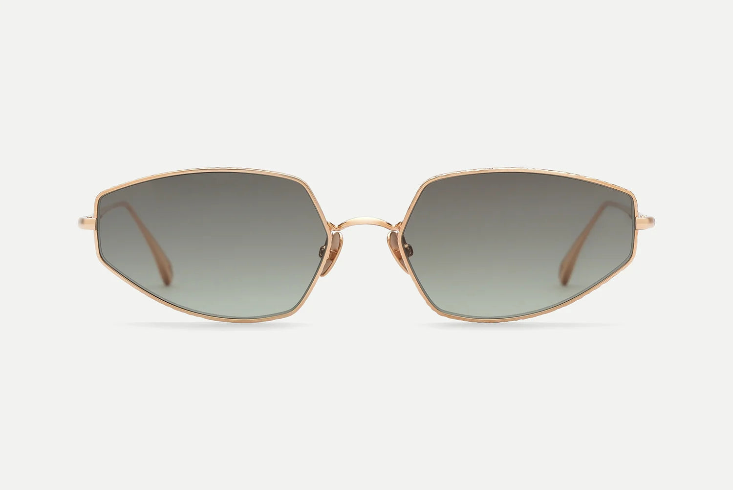 The AHLEM Yvonne sunglasses by AHLEM, featuring a gold-rimmed hexagonal frame and dark gradient lenses handcrafted in France and inspired by Bauhaus design, are presented against a plain white background, facing directly forward.