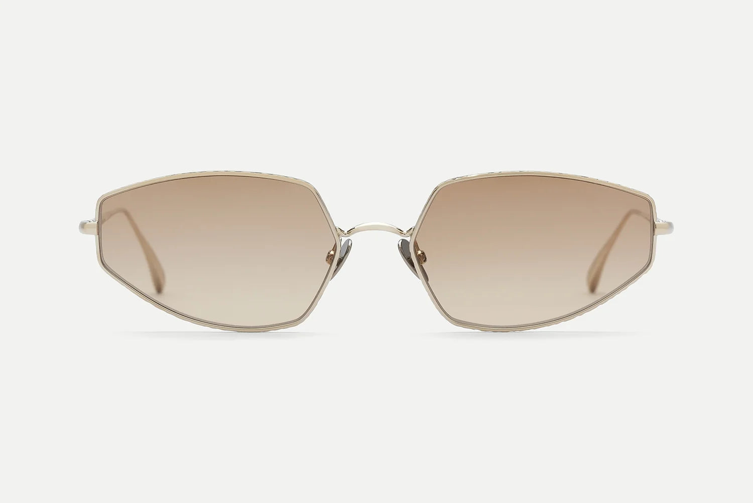 Front view of AHLEM Yvonne oversized geometric sunglasses by AHLEM, featuring gold wire frames and brown gradient lenses, handcrafted in France and inspired by Bauhaus design, displayed on a plain white background.