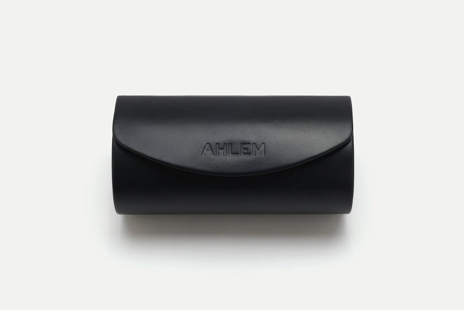 A black leather eyeglasses case with the brand name 'AHLEM' debossed on the front flap, shown on a clean white background.