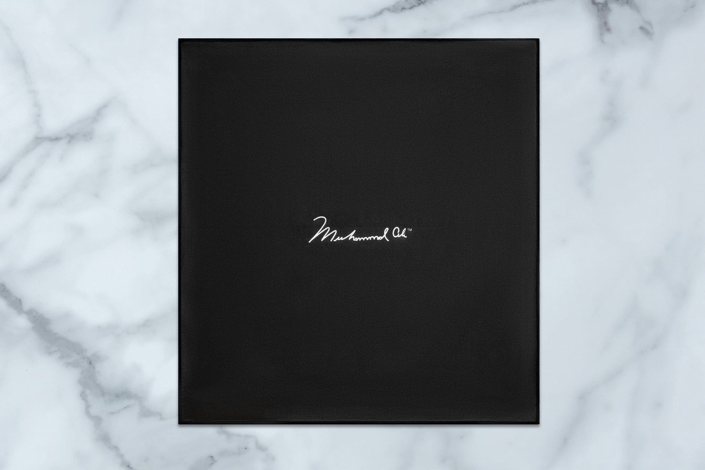 Black square box with 'Markhood' branding on a marble background