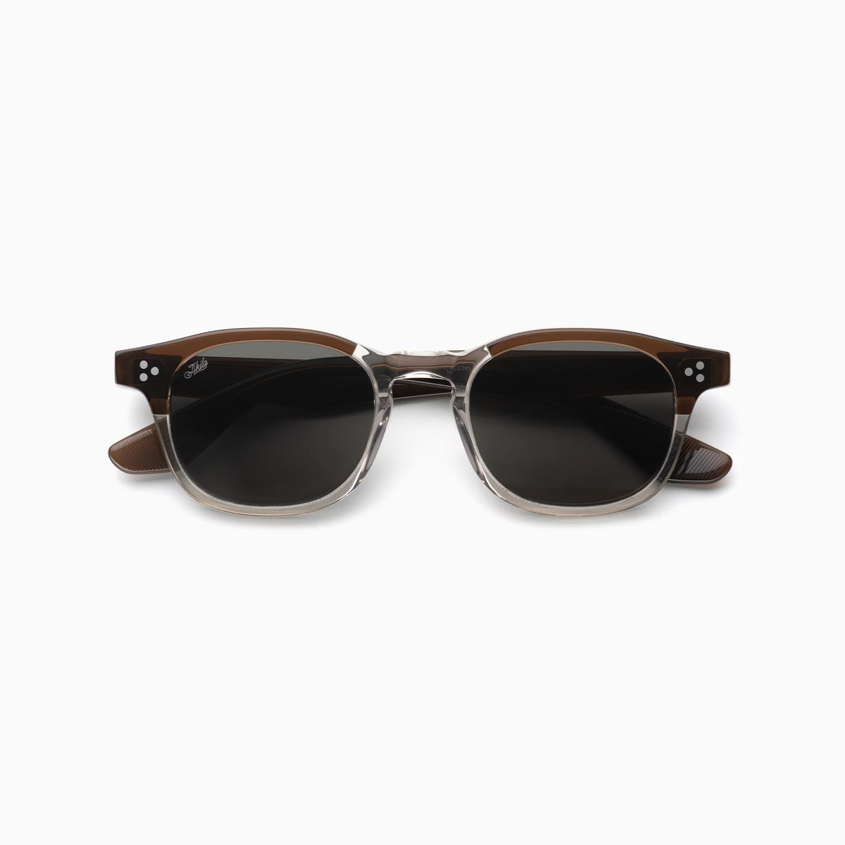 Front view of the Akila Atria sunglasses by Akila, featuring stylish clear lower and brown upper rims, dark lenses, and silver accents at the frame corners. The versatile shape and balanced silhouette provide a medium fit that complements a variety of face shapes.