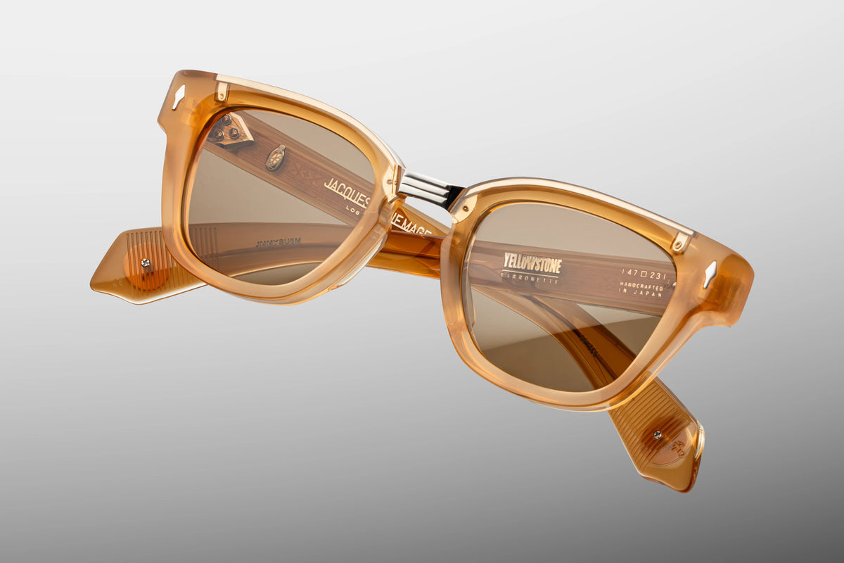 Jacques Marie Mage Yellowstone VII: Barronette In Brush sunglasses, handcrafted with translucent, honey-colored rectangular plant-based acetate frames and metal accents on the temple hinges.