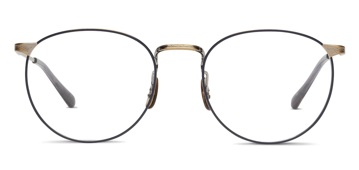 The SALT. Brower by SALT. is a pair of round, thin-framed Japanese titanium eyeglasses featuring gold accents on the bridge and temples, clear lenses, and black earpieces. These hypoallergenic frames are shown against a white background.