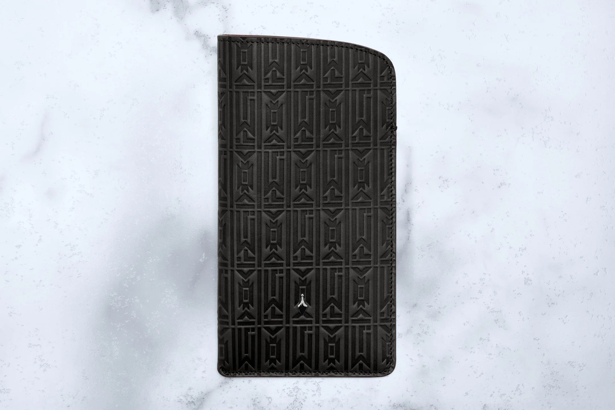 Black embossed phone case on a light gray textured background