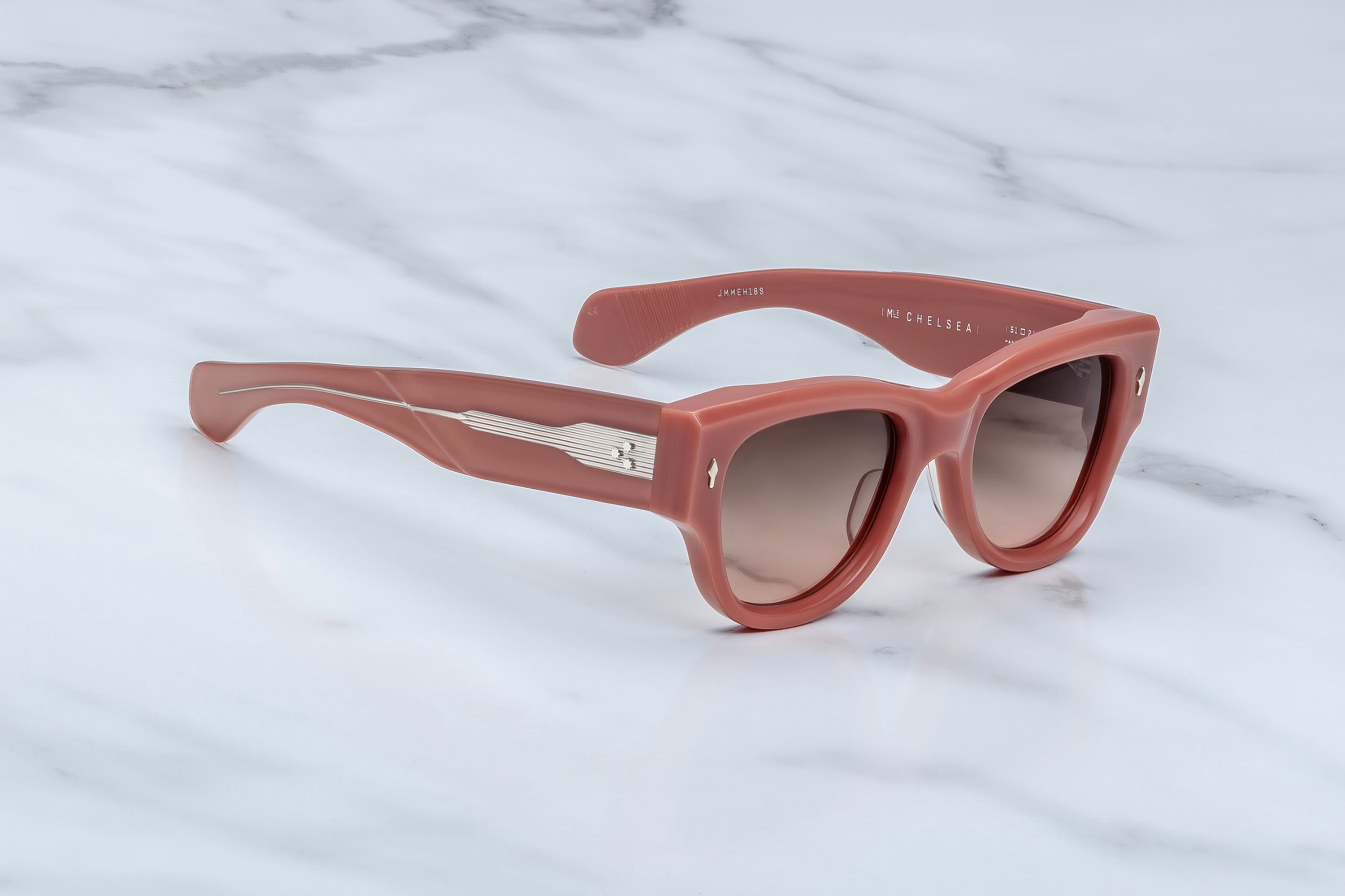 Pink sunglasses on a marble surface