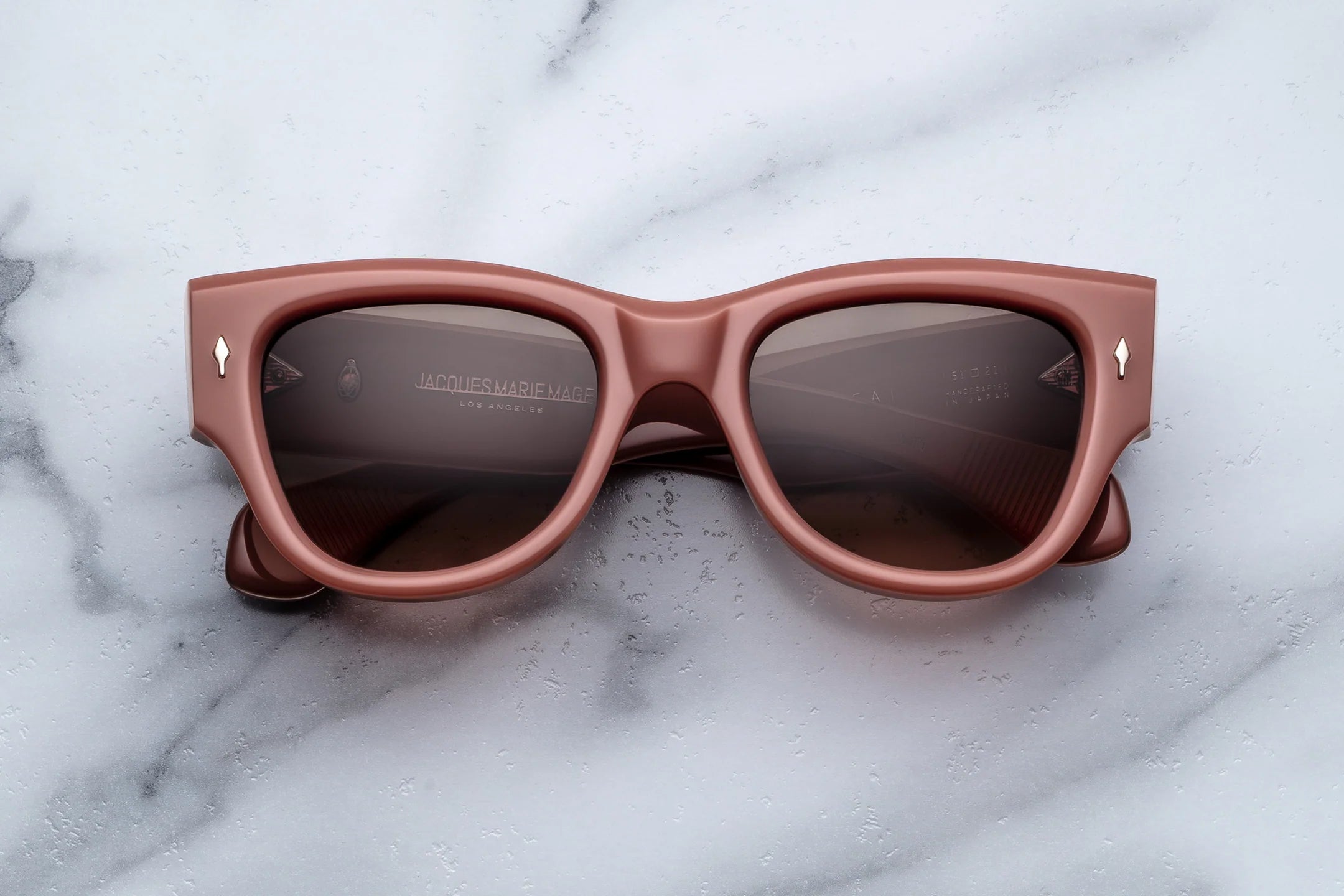Brown sunglasses on a marble surface