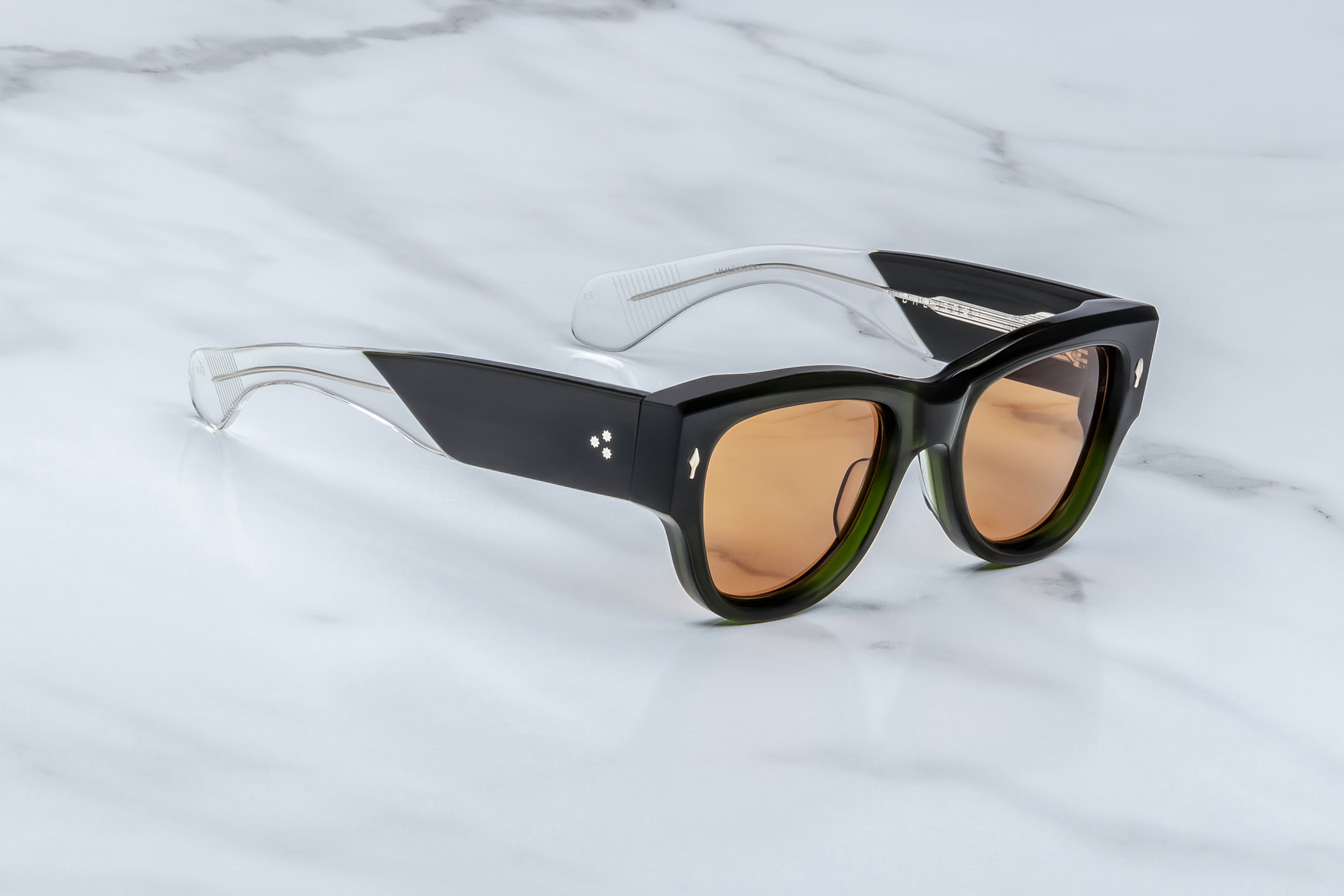 Sunglasses with black frame and brown lenses on a marble surface