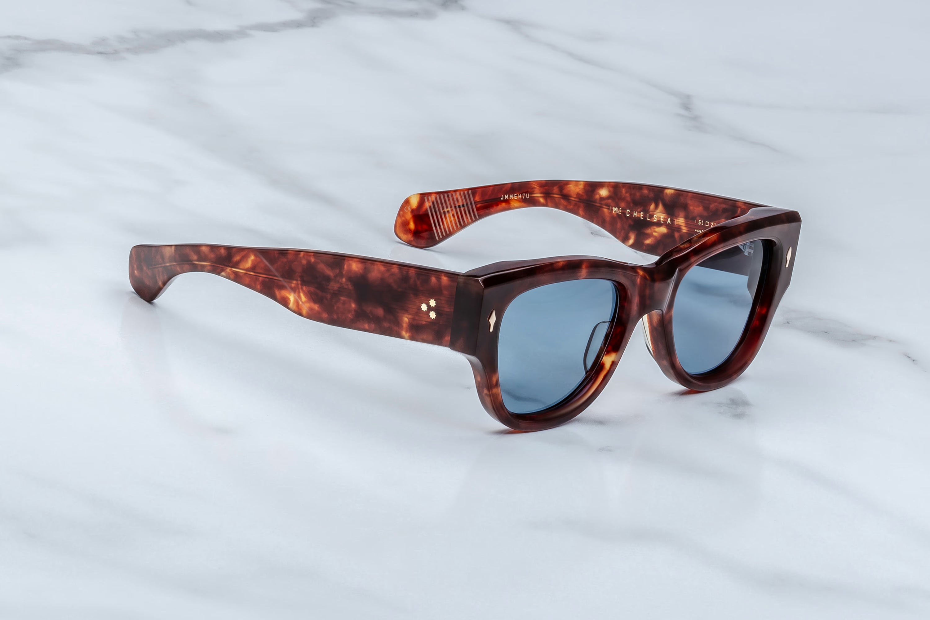 Tortoiseshell sunglasses on a marble surface