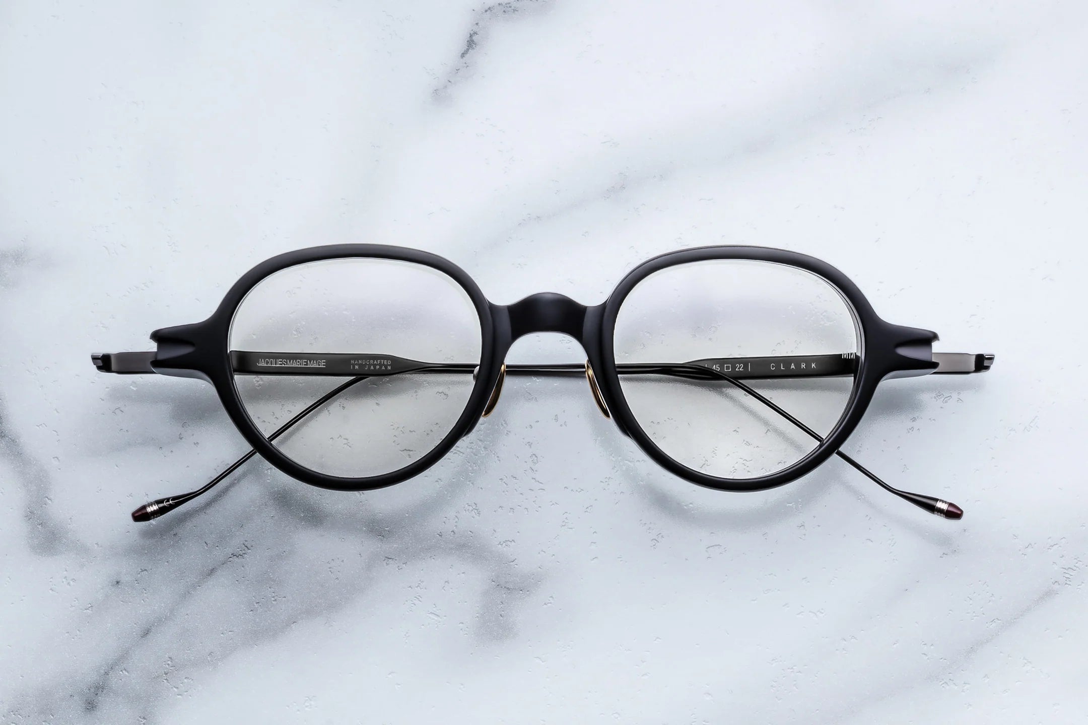 Black eyeglasses on a marble surface
