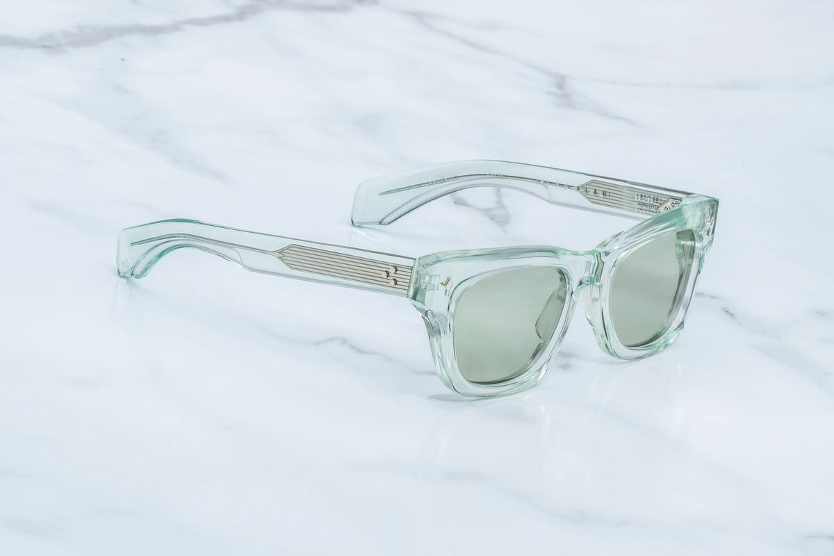Jacques Marie Mage Dealan sunglasses featuring light green translucent frames, silver temple accents, rectangular lenses, and custom photochromic lenses.