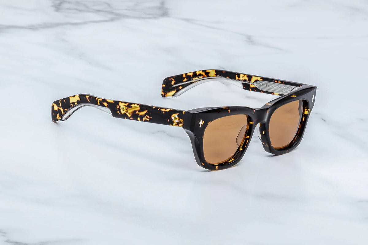 Jacques Marie Mage Dealan tortoiseshell-patterned acetate sunglasses with a thick, angular frame and light brown lenses inspired by the ‘60s.