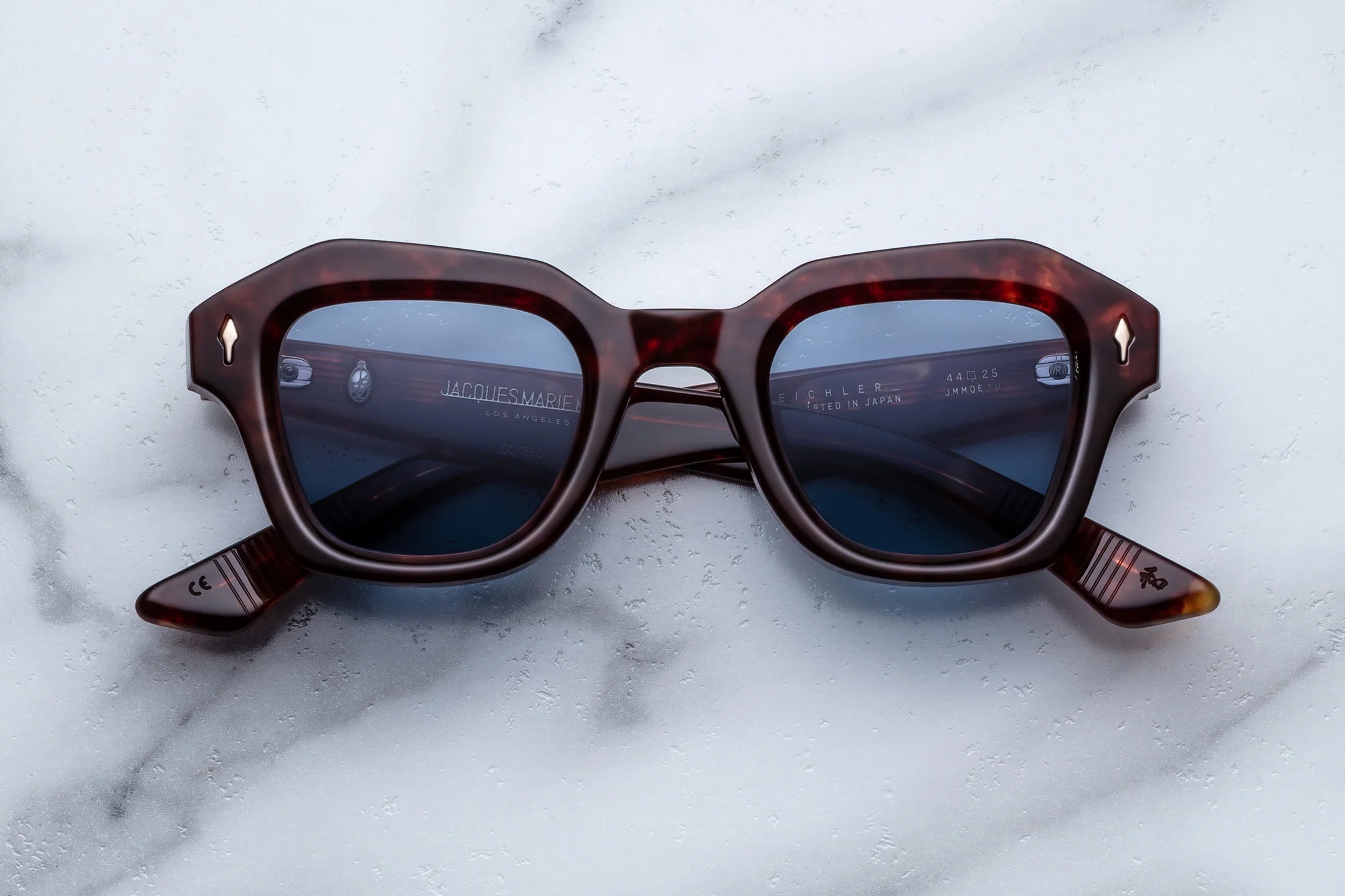 Sunglasses with a tortoiseshell frame on a marble surface