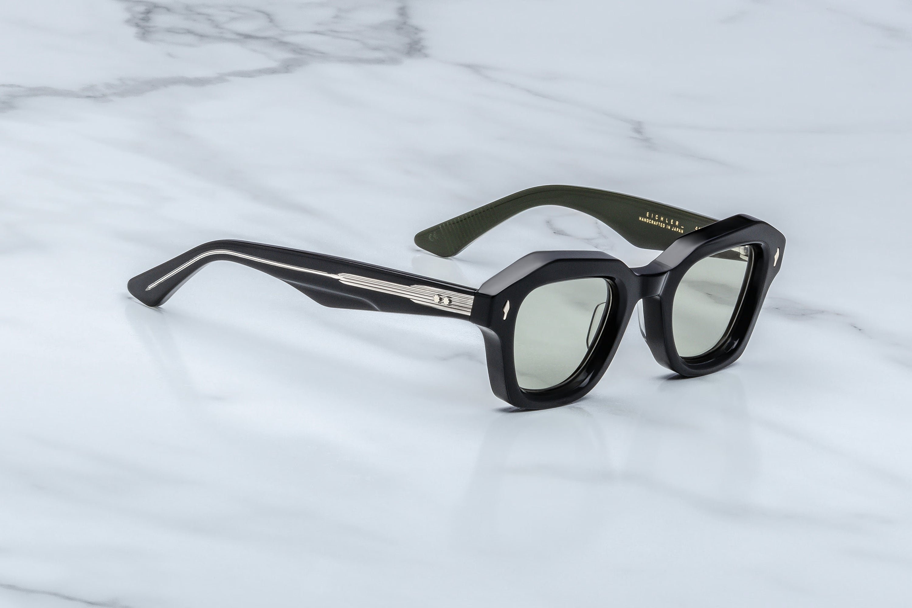 Black sunglasses on a marble surface