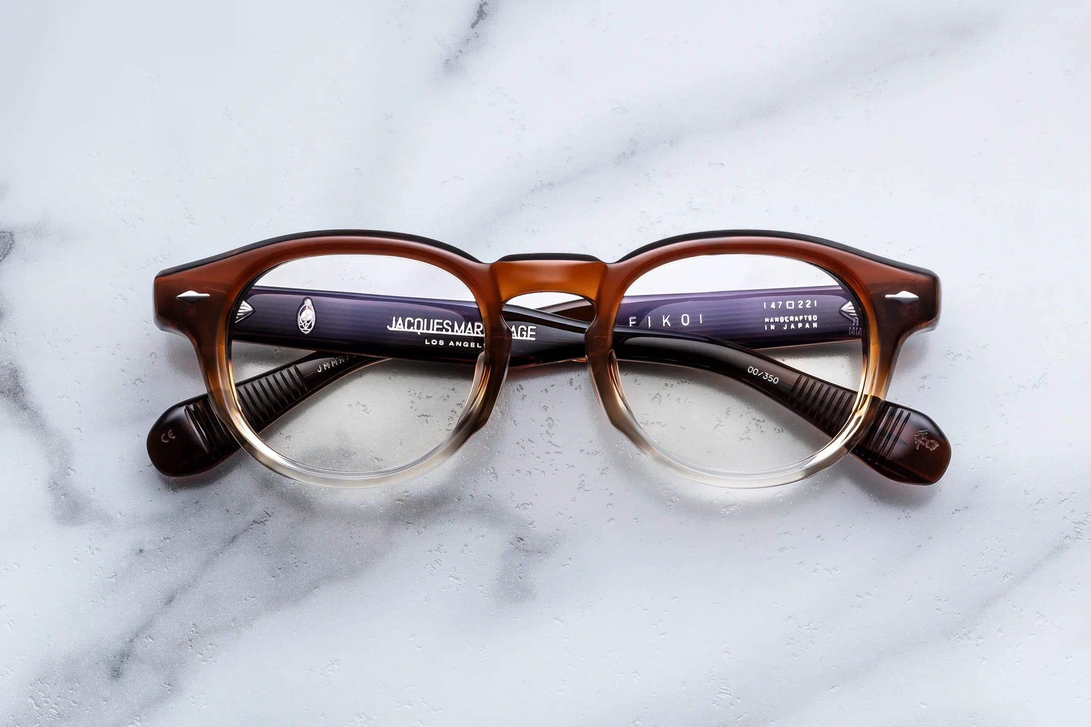 Brown eyeglasses on a marble surface