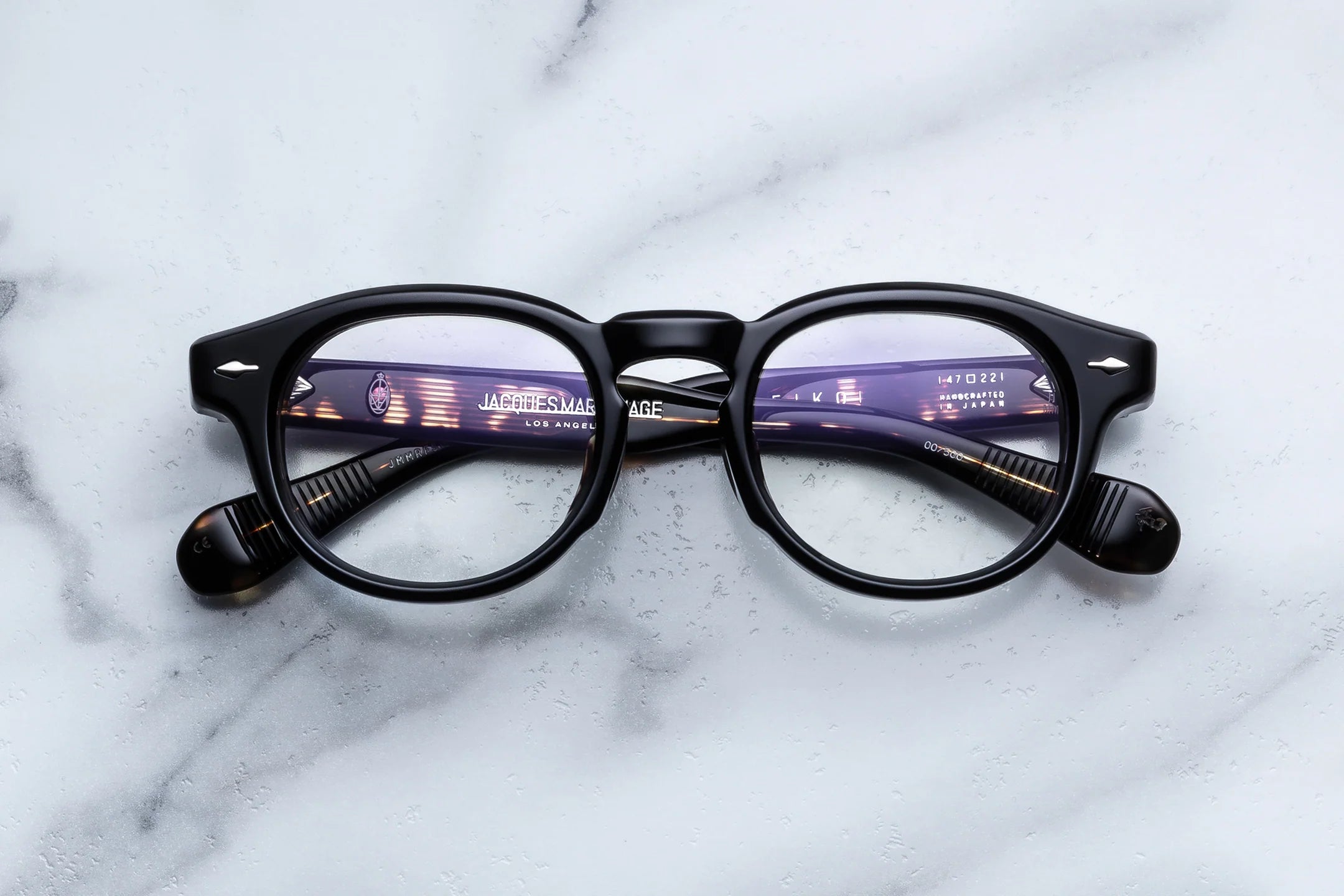 Black eyeglasses on a marble surface