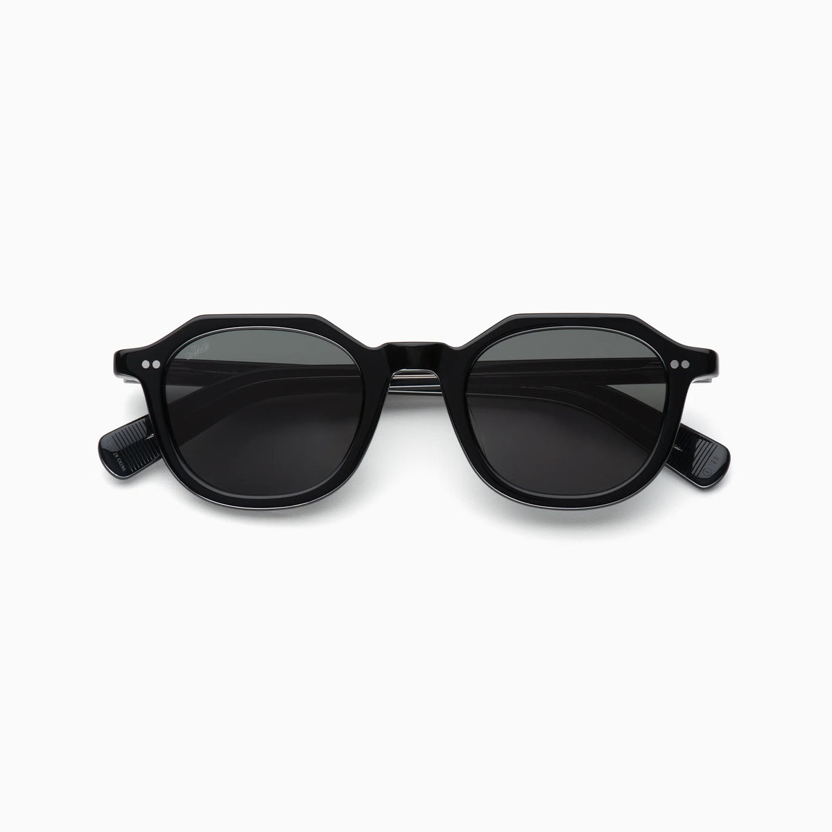 The Akila Eira sunglasses by Akila feature round lenses and thick black frames, showcased from the front against a plain white background, capturing the spirit of contemporary eyewear with subtle nods to mid-century French crown panto design.