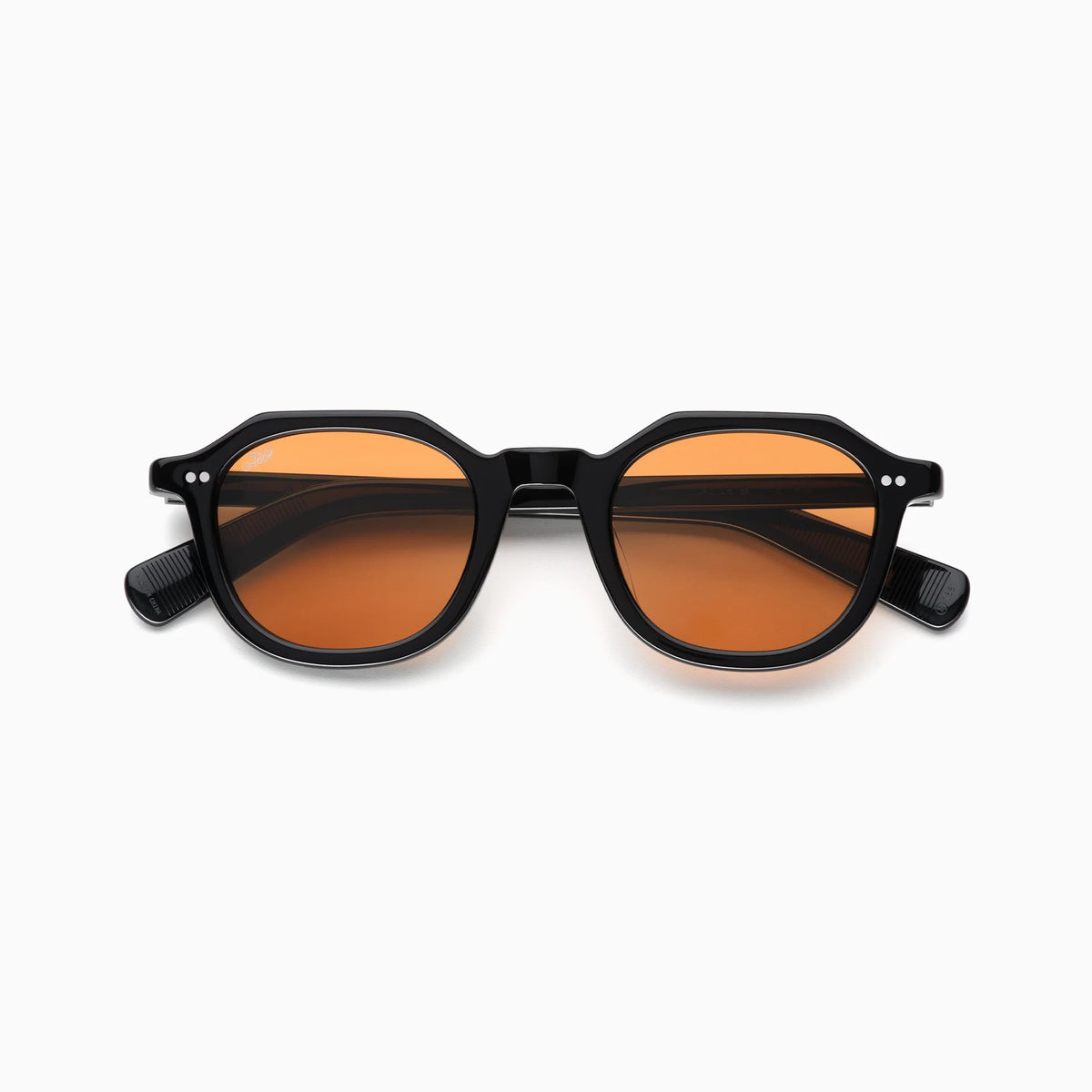 Akila Eira sunglasses by Akila, shown on a white background, feature black frames and round, orange-tinted lenses. Inspired by mid-century French crown panto style, these contemporary eyewear pieces are displayed with their arms folded out to the sides.