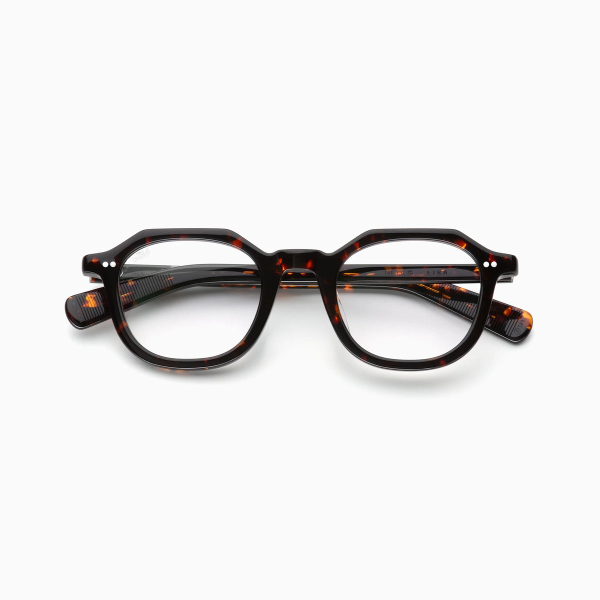 Akila Eira by Akila features round tortoiseshell optical frames with a bold, thick design and silver dot accents on the upper corners, inspired by the classic French crown panto style, displayed against a plain white background.